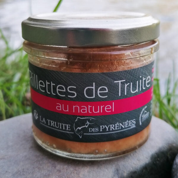 Émietté de truite au naturel en pot de la maison "La truite des Pyrénées" posé au bords d'une rivière.