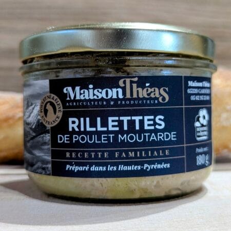 une photo de rillette de poulet à la moutarde, en gros plan et en fond un baguette de pain, sur fond de bois