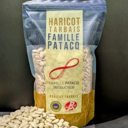 Un tas de Haricots Tarbais devant un paquet de 1kg de Haricots Tarbais cultivés à Jer par la ferme Patacq